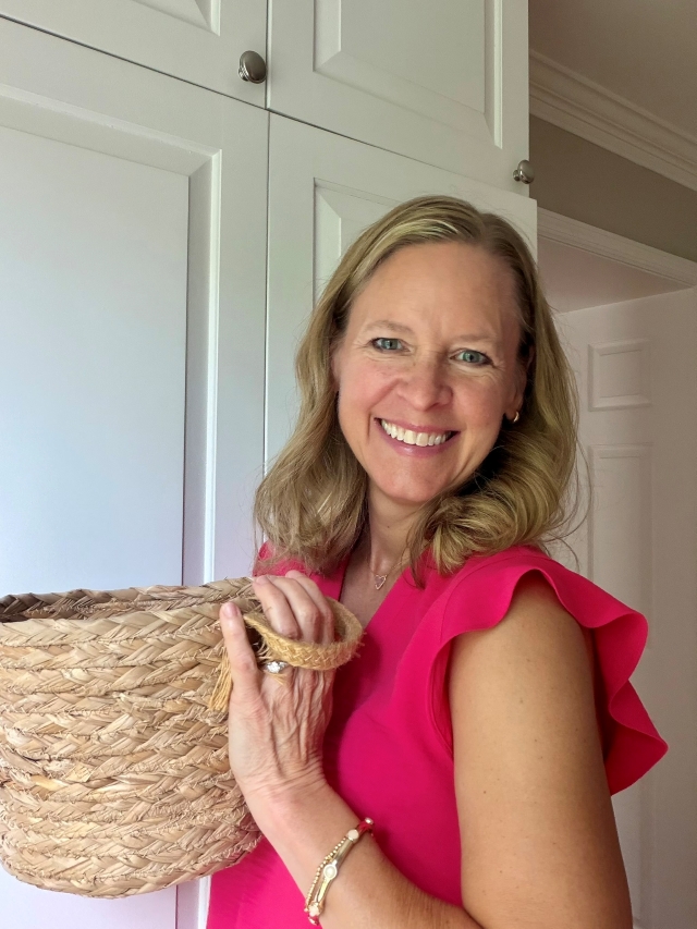 Wendy Sauer organizing books by color on a shelf